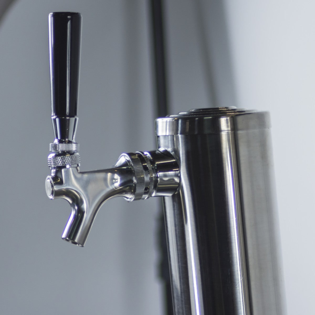 Close-up view of the Prodis single tap keg cooler with stainless steel tap tower with black handle