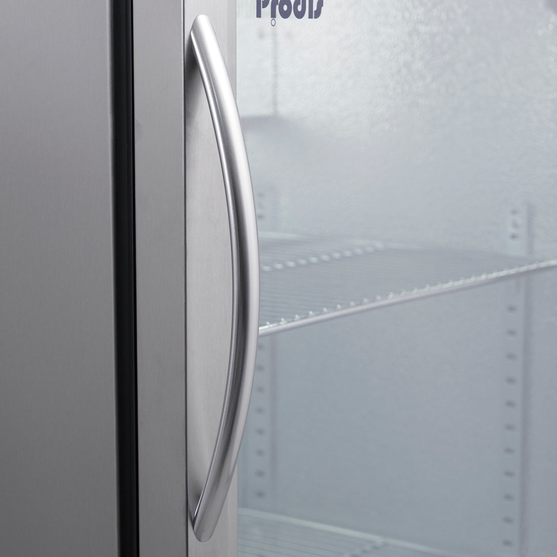 Curved stainless steel door handle on Prodis triple door bottle cooler with double glazed glass and chrome shelving.