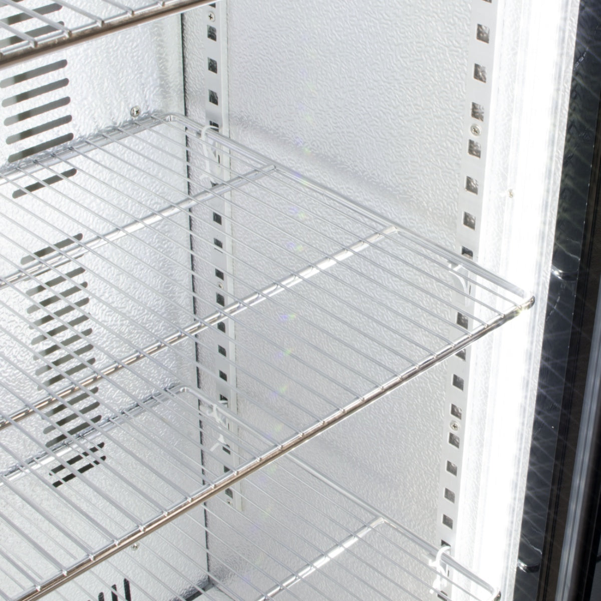 Interior view of the Prodis bottle cooler with multiple chrome wire shelves, offering versatile storage for bottles and canned drinks