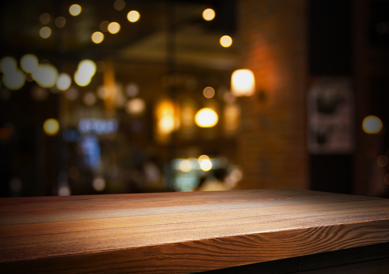 close up image of a bar counter with  lights shining in the background