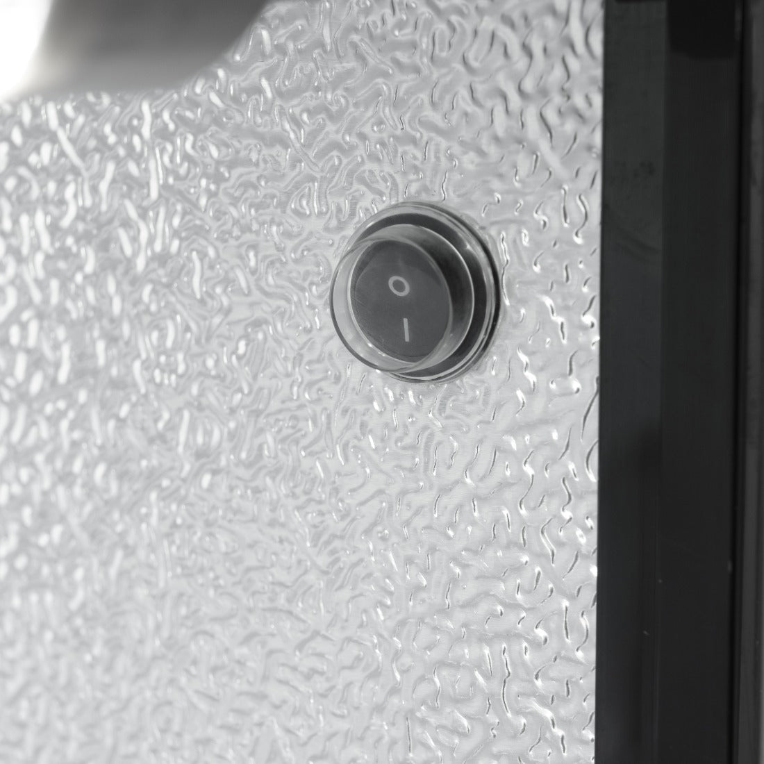 Close-up of internal light switch inside Prodis low energy triple door bottle cooler with textured aluminium lining.